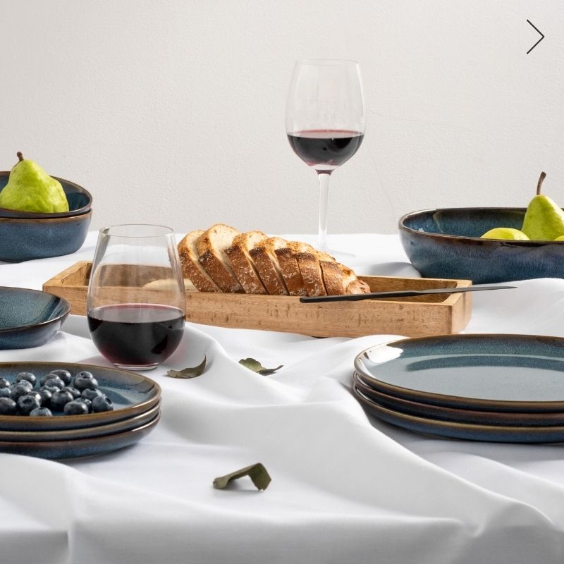 Ceramic plates and glass drinkware on the dining table