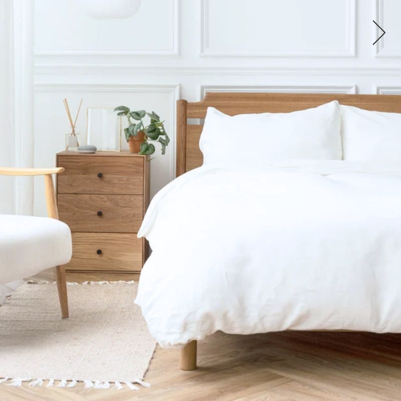 White duvet cover set on a wooden bed