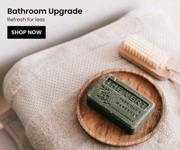 Towel and soap bar on top of wooden soap bar holder